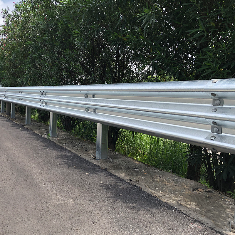 Finished galvanized Thrie-beam guardrail installed beside a road